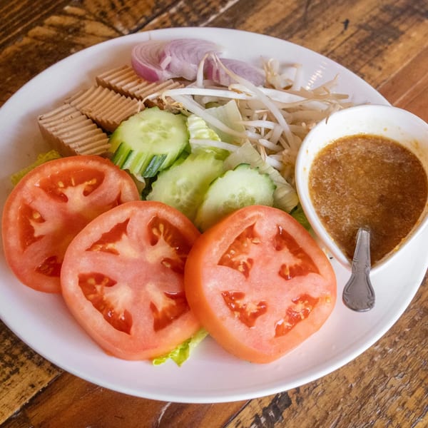 Siwa Thai Restaurant's fresh salad with tomatoes, cucumbers, tofu, bean sprouts, and red onions with dressing.